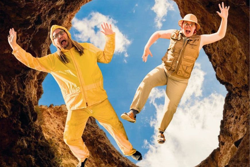 two people, one in adventurers clothing, and one in a yellow raincoat, both look like they're falling down a hole.